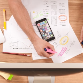 paper charts with a smart phone on top